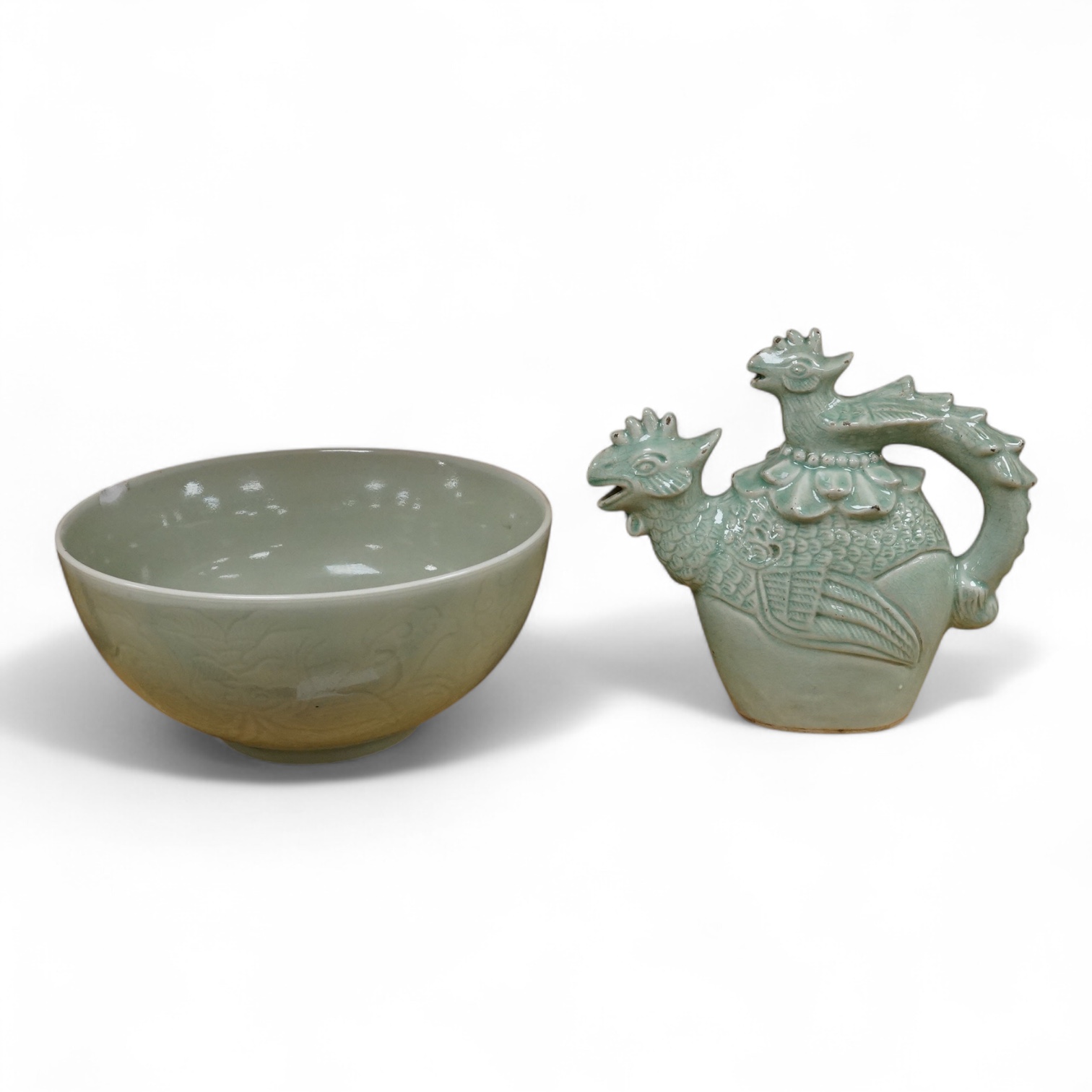 A Chinese celadon glazed ‘Phoenix’ wine ewer, late 19th century/ early 20th century, and a celadon glazed bowl, largest 26cm high